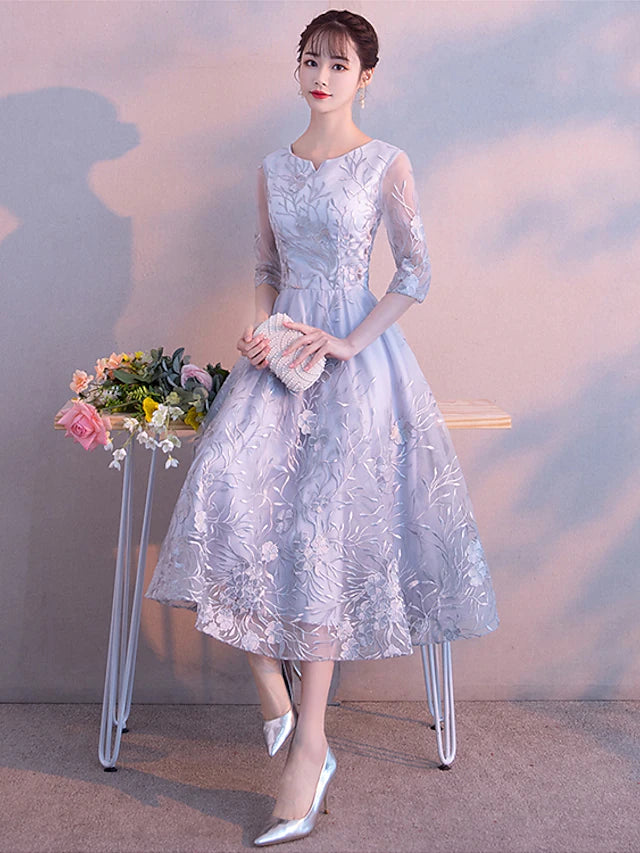 Close-up of the delicate lace detail on the 3/4 sleeve of the dress.