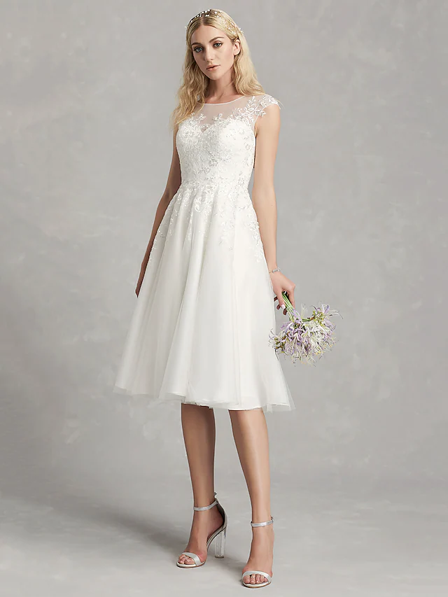 Close-up of the lace and applique details on the wedding dress.