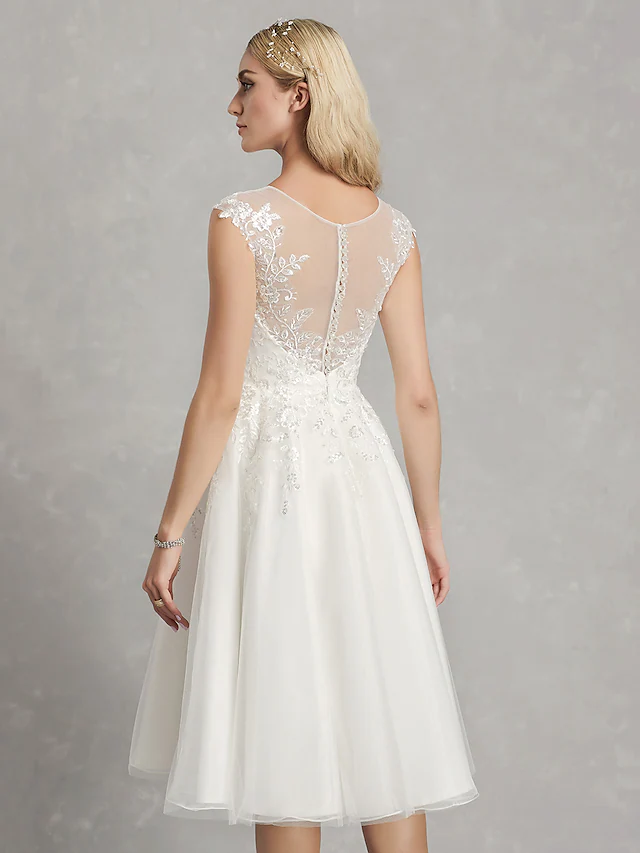 Detail of the cap sleeve and jewel neckline of the bridal gown.