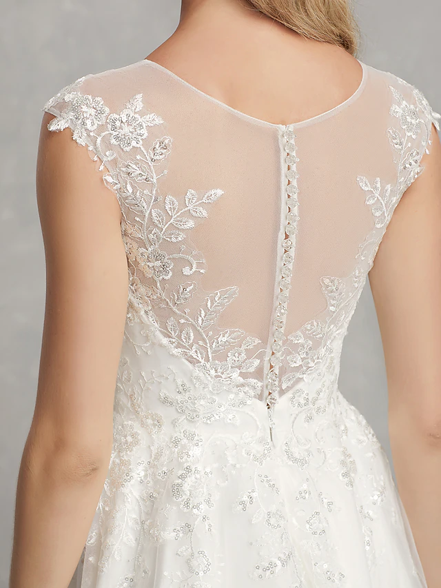 Bride posing in the A-Line tea length wedding dress.