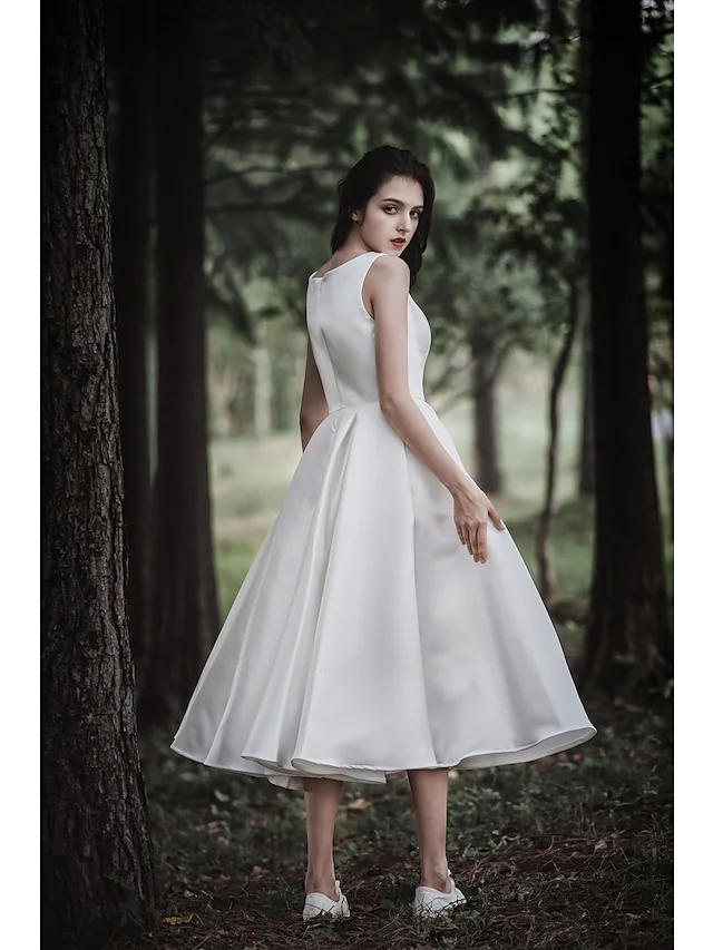 Side profile of the simple white tea length bridal gown.