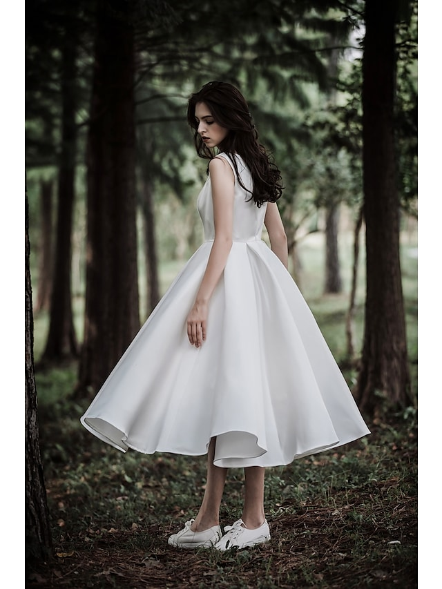Detail of the chiffon over satin fabric on the tea length wedding dress.