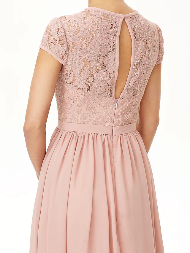 Flowing chiffon skirt and sash detail of A-line bridesmaid dress.