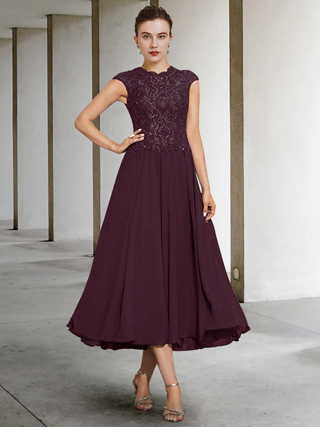 Elegant A-Line Mother of the Bride dress with jewel neck and appliques.