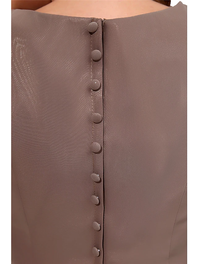 Close-up of chiffon fabric and jewel neckline.