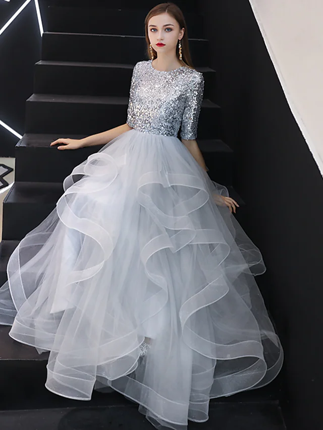 Elegant A-Line jewel neck bridesmaid dress with sequin details and floor-length tulle.