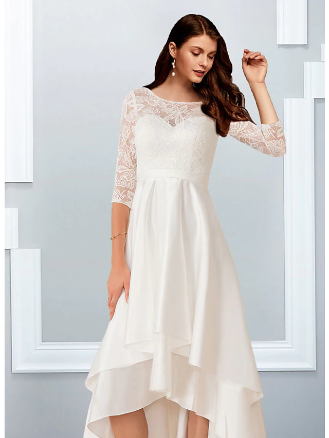 Full length view of the beach wedding dress with flowing asymmetrical ruffles.