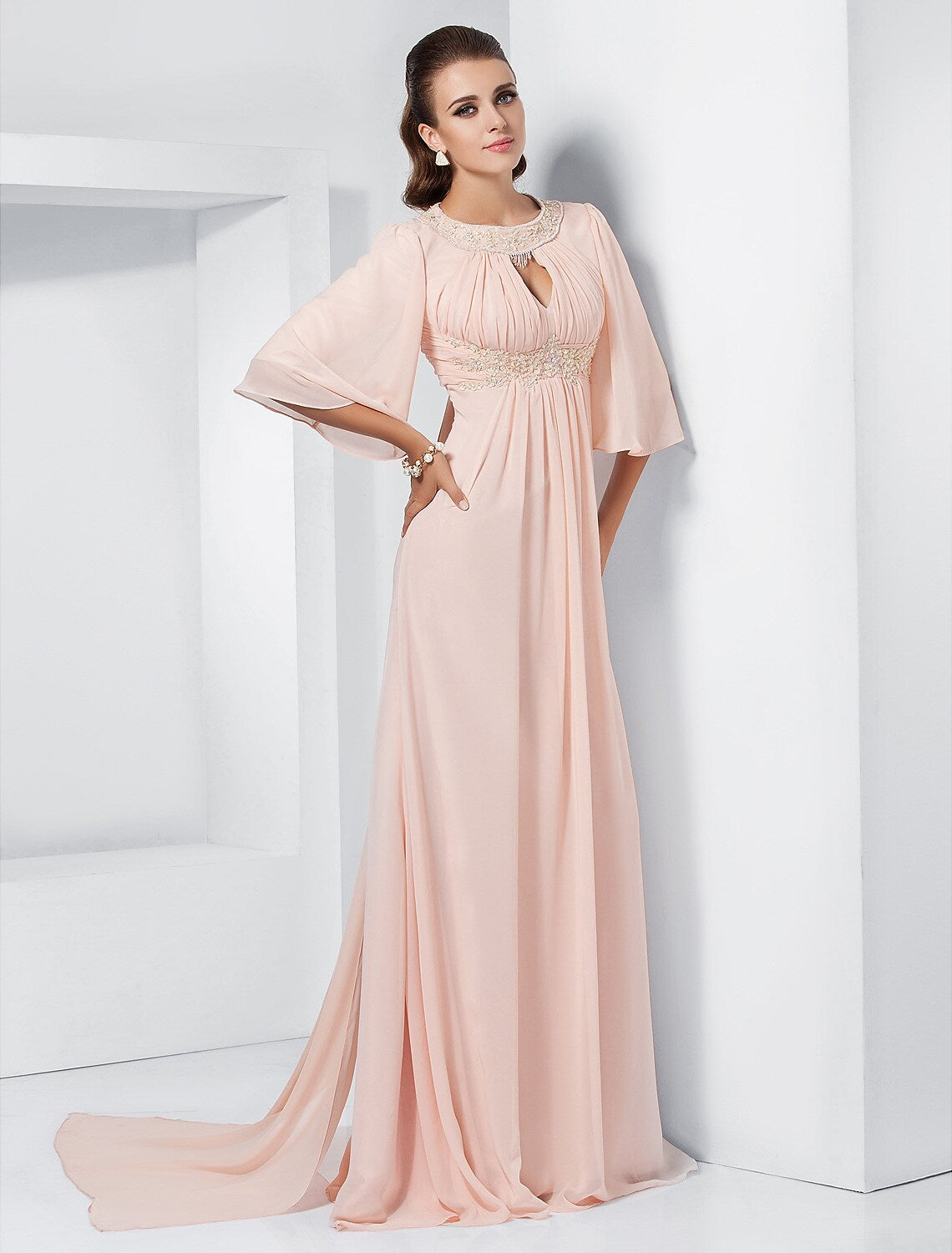 Elegant A-line chiffon gown with jewel neck and half sleeves.