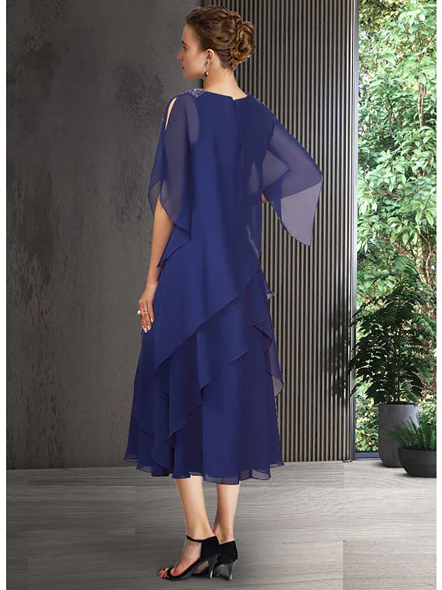 Back view of an A-Line blue tea length dress with cascading ruffles.