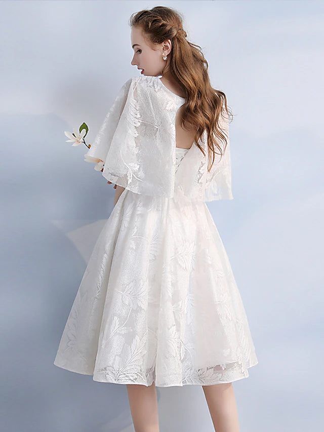 Back view of the knee-length lace cocktail dress.