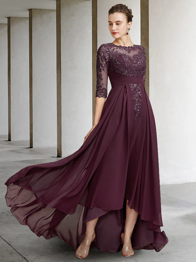 Woman wearing an elegant A-line mother of the bride dress with a jewel neck and half sleeves.