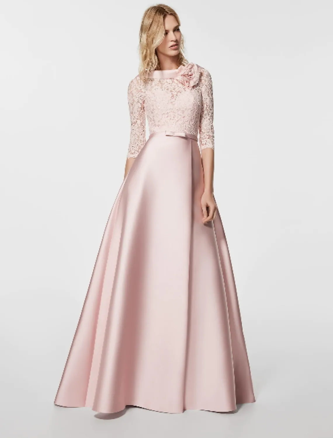 Woman wearing an elegant A-line satin evening gown with a jewel neck and half sleeves.