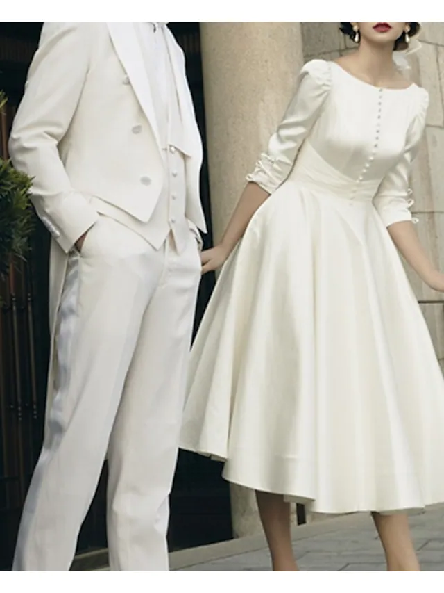 Full view of A-Line tea length white wedding dress.