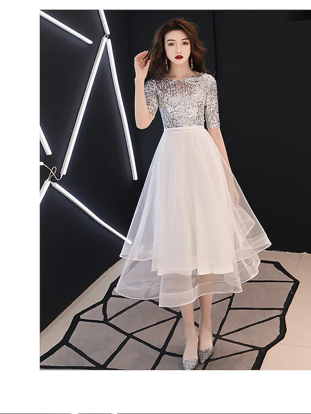 Side view of the white tea-length A-Line dress, showcasing the satin fabric and sequin details.