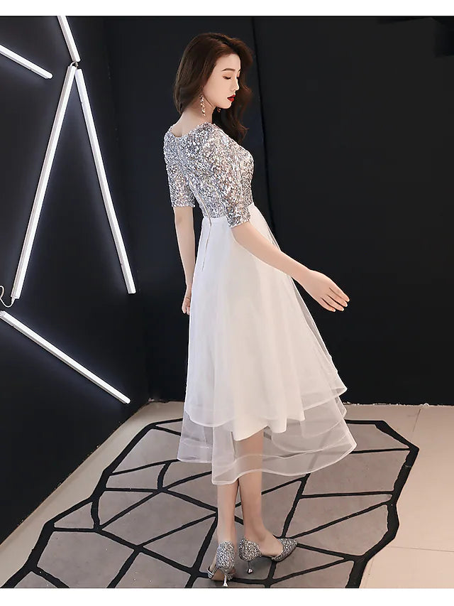 Close-up of the sequin tier and satin fabric on the white A-Line cocktail dress.