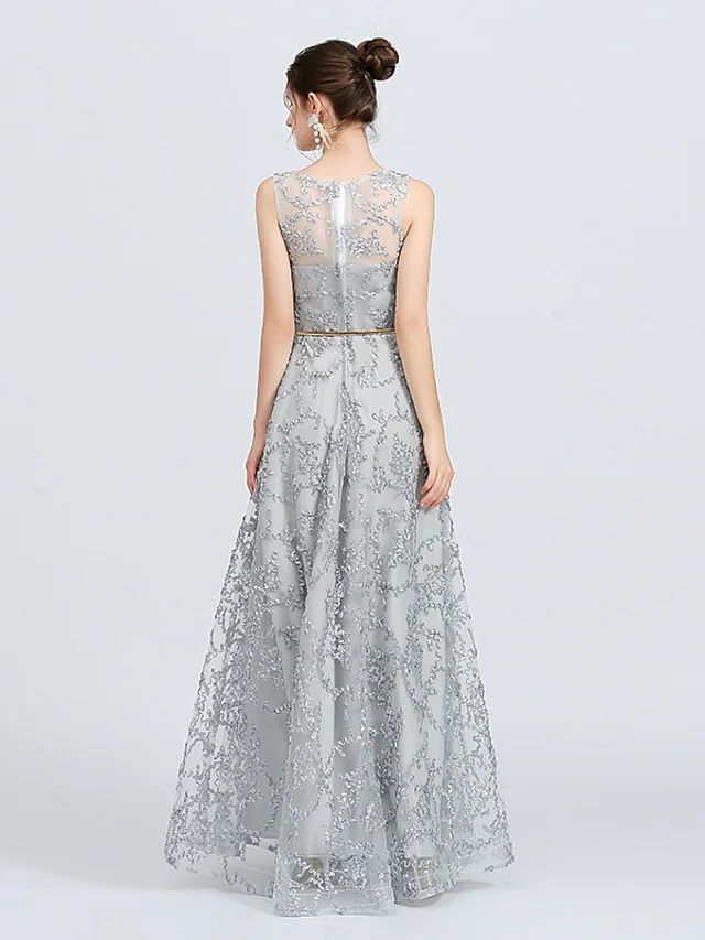 Close-up of delicate lace appliques and ribbon sash on bridesmaid dress.