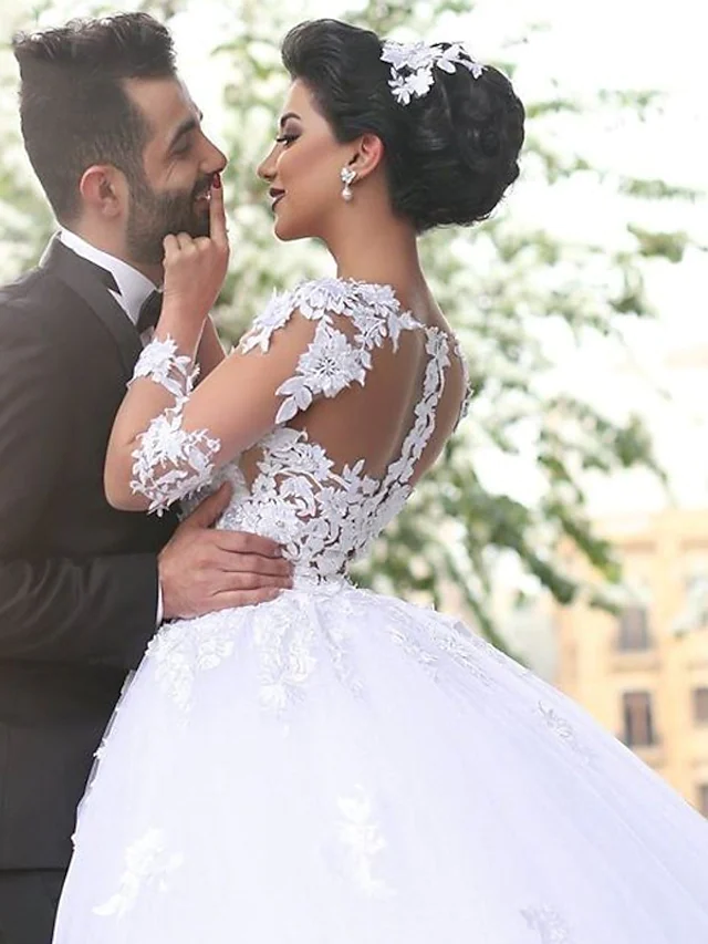 Back view of A-Line wedding dress showing lace illusion sleeves and court train.