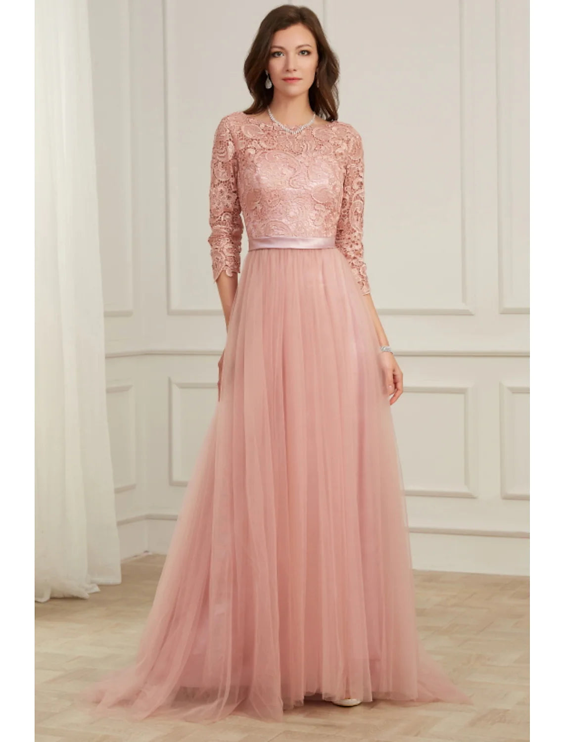 Elegant A-line lace evening gown with long sleeves and jewel neck.