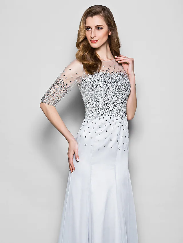 Close-up of the jewel neck and half sleeve detail on the dress.