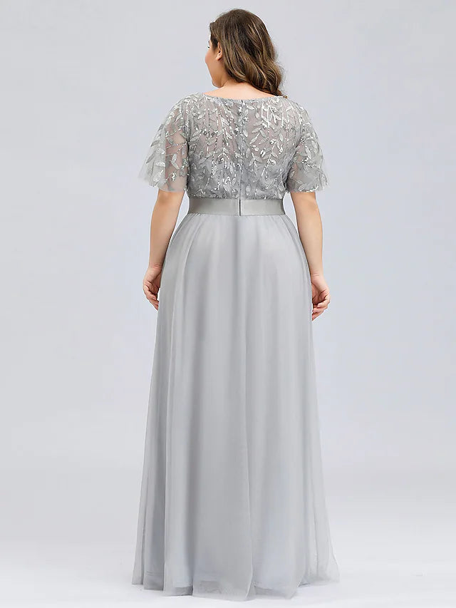 Plus size floor-length gown featuring delicate appliques and a flowing skirt.