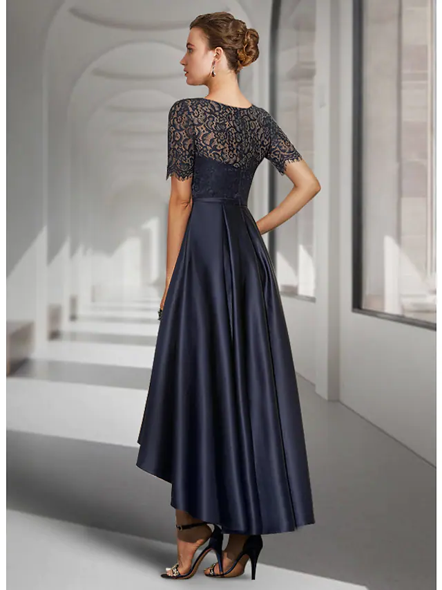 Side view of the A-line mother of the bride dress, showing asymmetrical pleats and satin fabric.