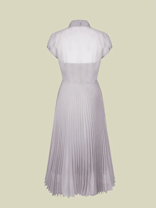 Side view of a tea-length organza A-line dress with short sleeves.