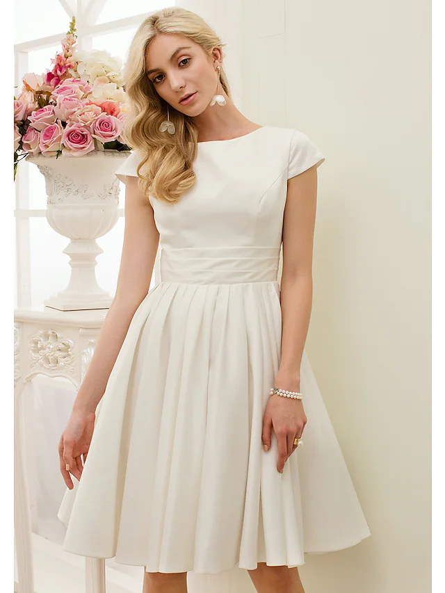 Model wearing the A-line white wedding dress with sash ribbon.
