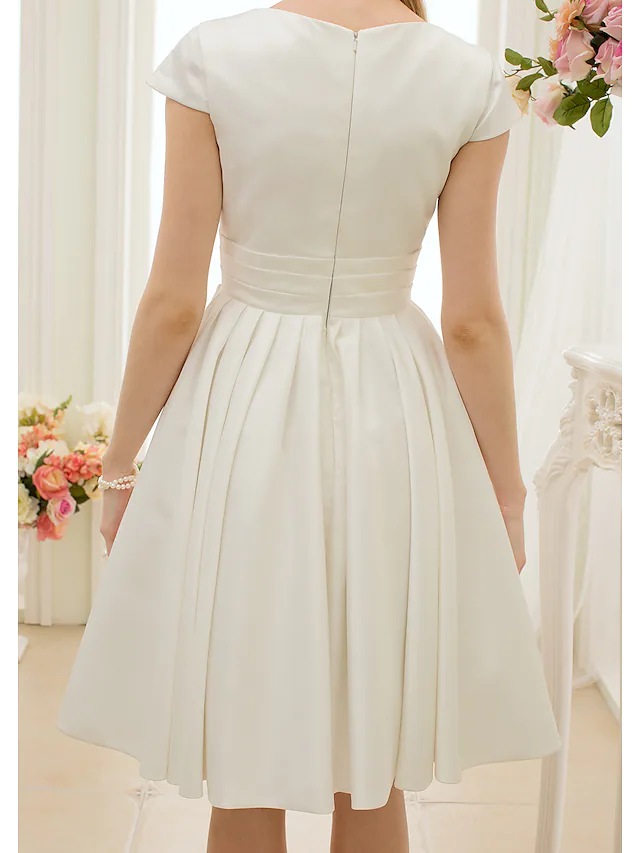 Detail of the satin fabric and sash ribbon on the wedding dress.