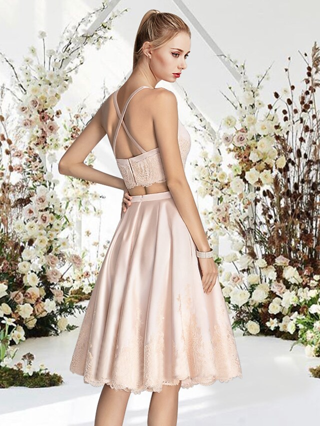 Back view of an A-line mini cocktail dress, showcasing the sleek satin fabric.