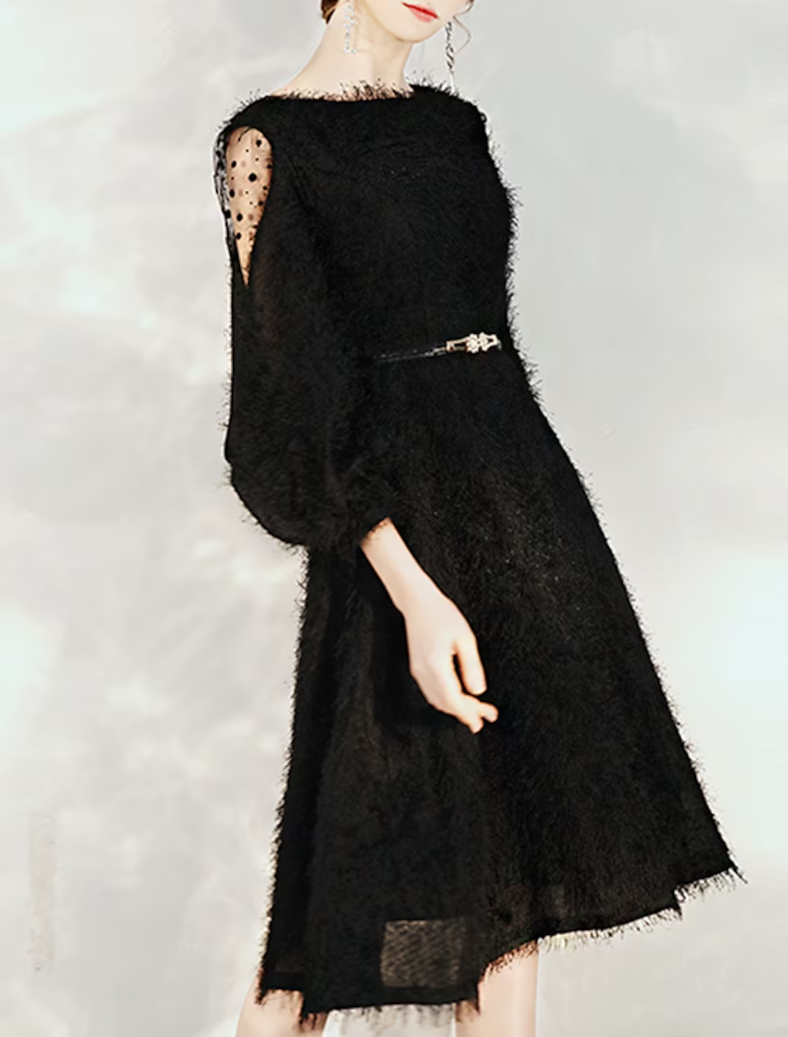 Close-up of the jewel neck and 3/4 sleeves of the cocktail dress.