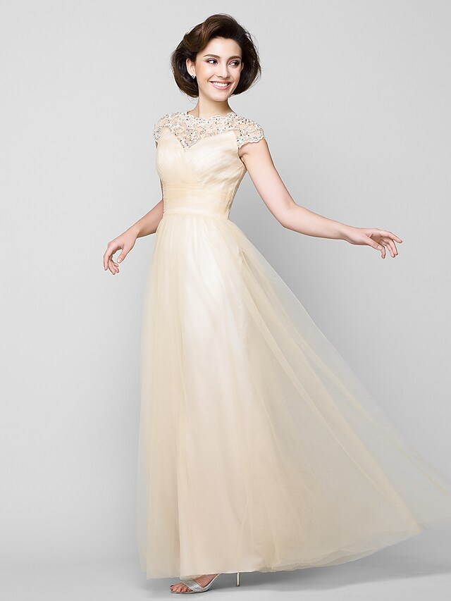 Close-up of the jewel neck and intricate criss-cross beading on the dress.