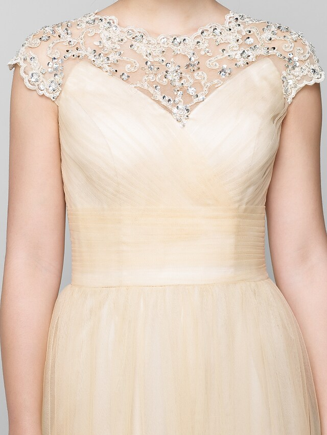 Mother of the Bride dress showcasing its flowing tulle skirt and elegant silhouette.