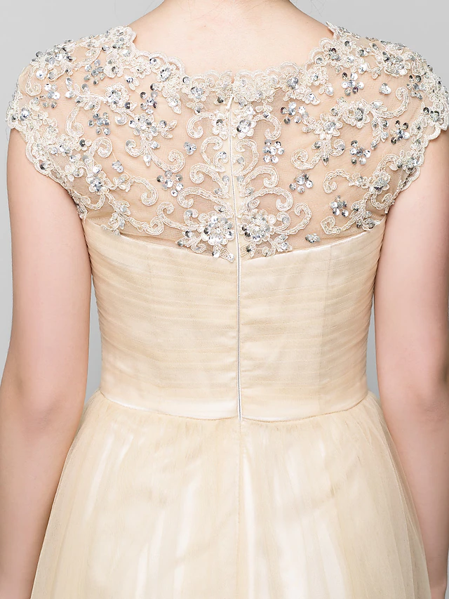 Detail of the sheer jewel neck and beading on the A-Line formal dress.