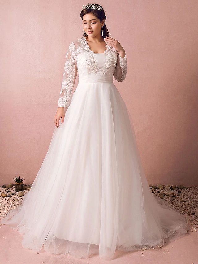 Elegant A-line wedding dress with jewel neck and long illusion lace sleeves.