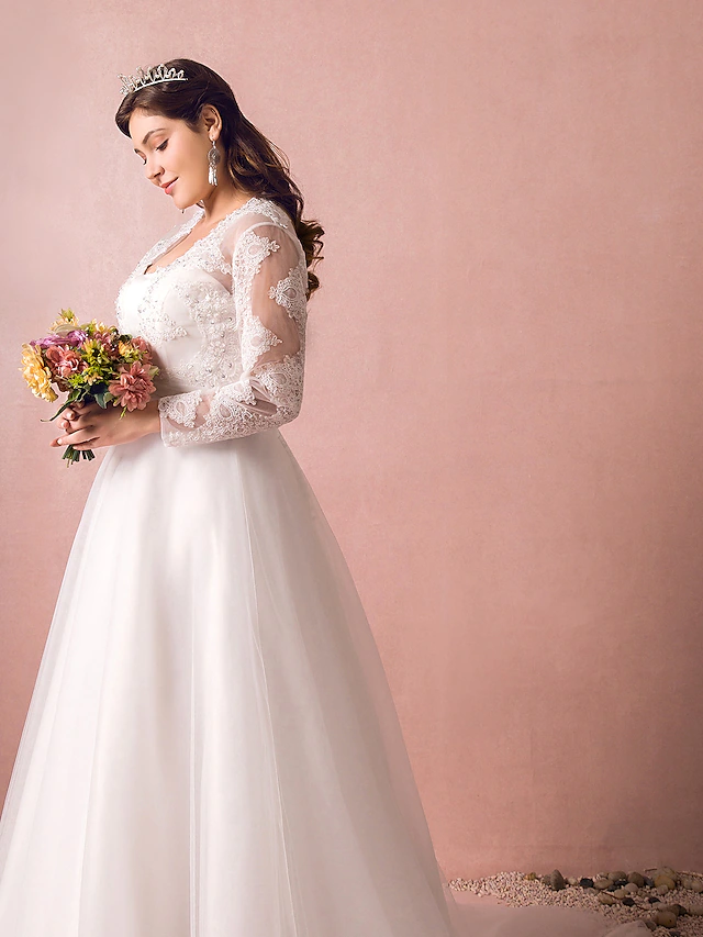 Close-up of the jewel neckline and intricate lace on the wedding dress.