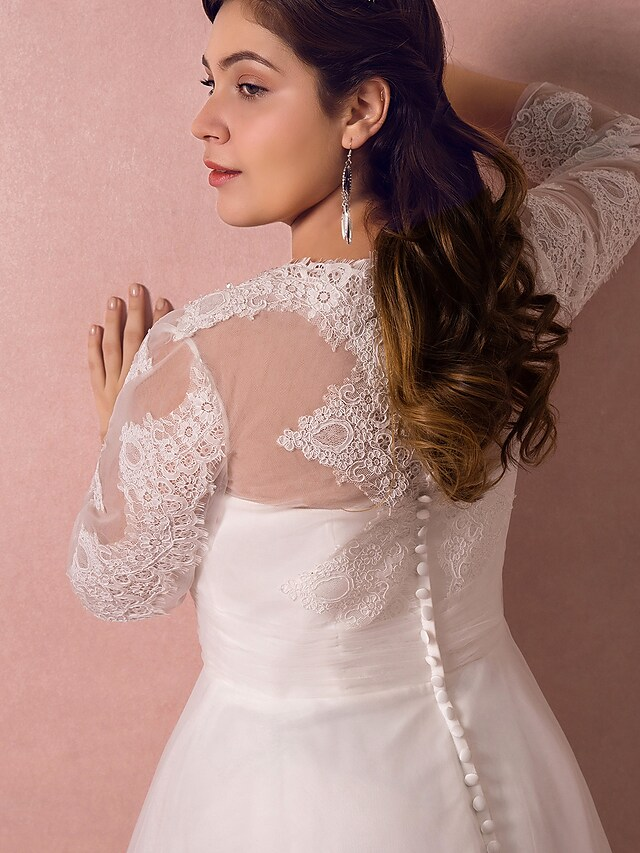 Full length view of the A-line wedding gown with its flowing court train.