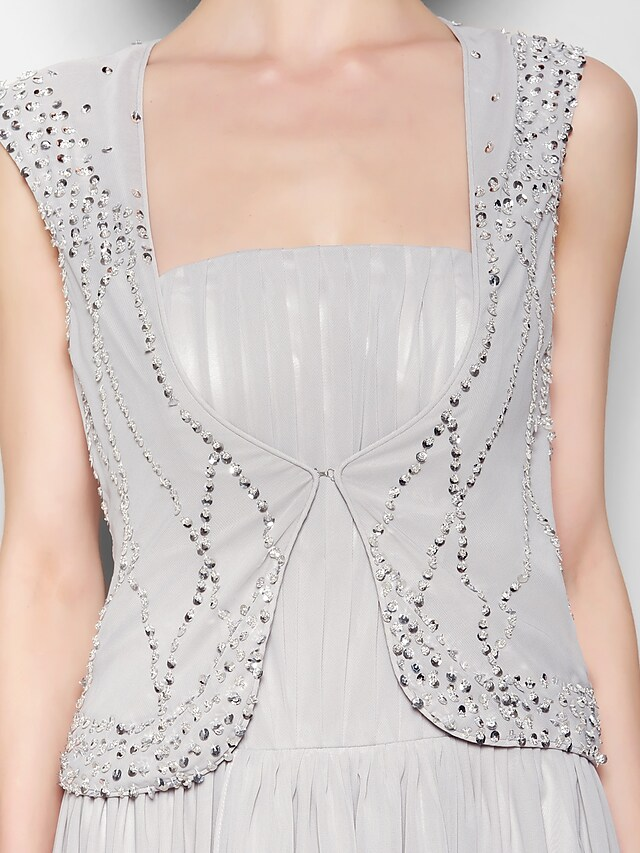 Detail of the elegant draping on the chiffon A-line skirt.
