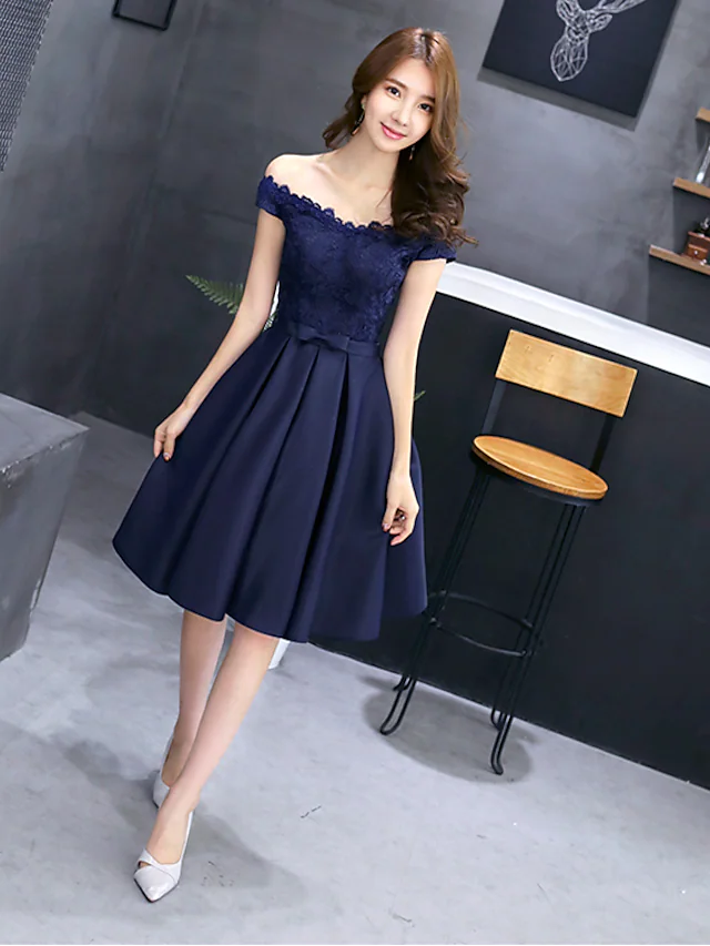 Woman modeling an A-line off-shoulder floral lace cocktail dress.