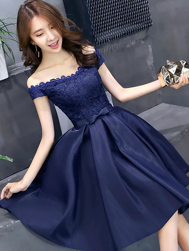 Detail of floral lace and pleats on the A-line dress.