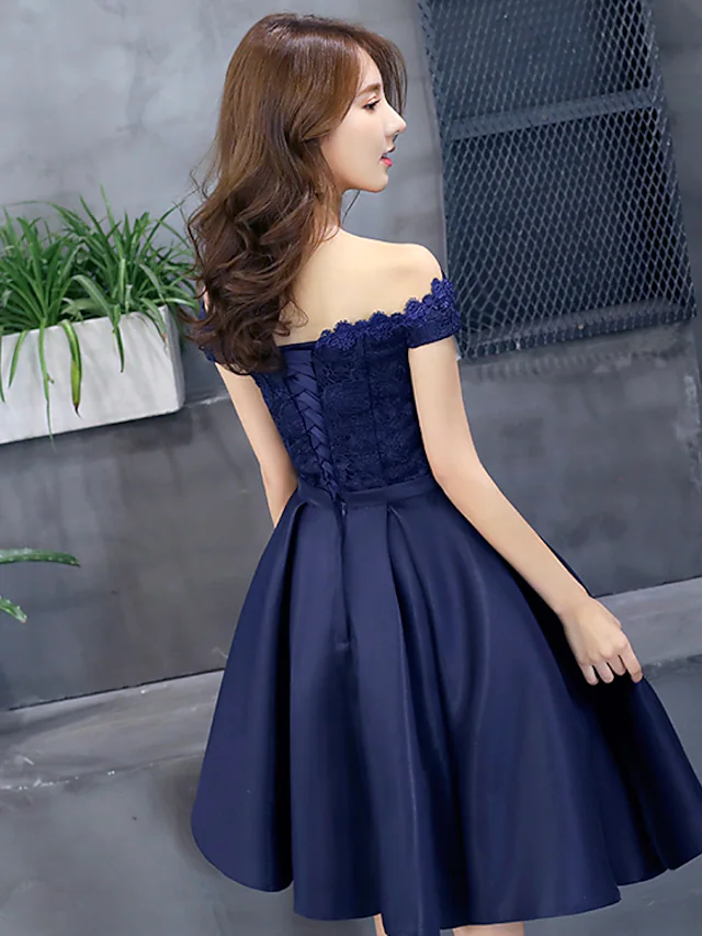 Back view of the A-line off-shoulder floral lace mini dress.