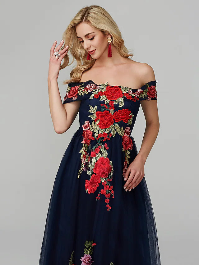 Detailed view of the tulle skirt and lace embroidery on the prom dress.