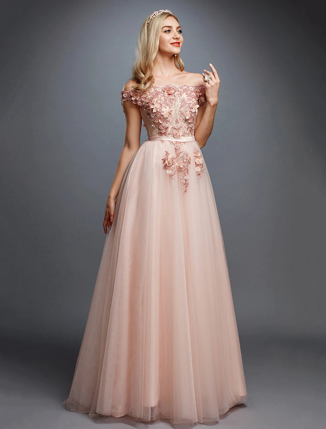 Model wearing an elegant A-line off-shoulder floral lace gown with a sweep train.