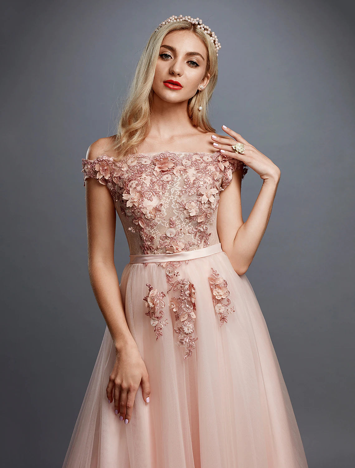 Back view of the A-line off-shoulder floral dress, showcasing the sweep train.