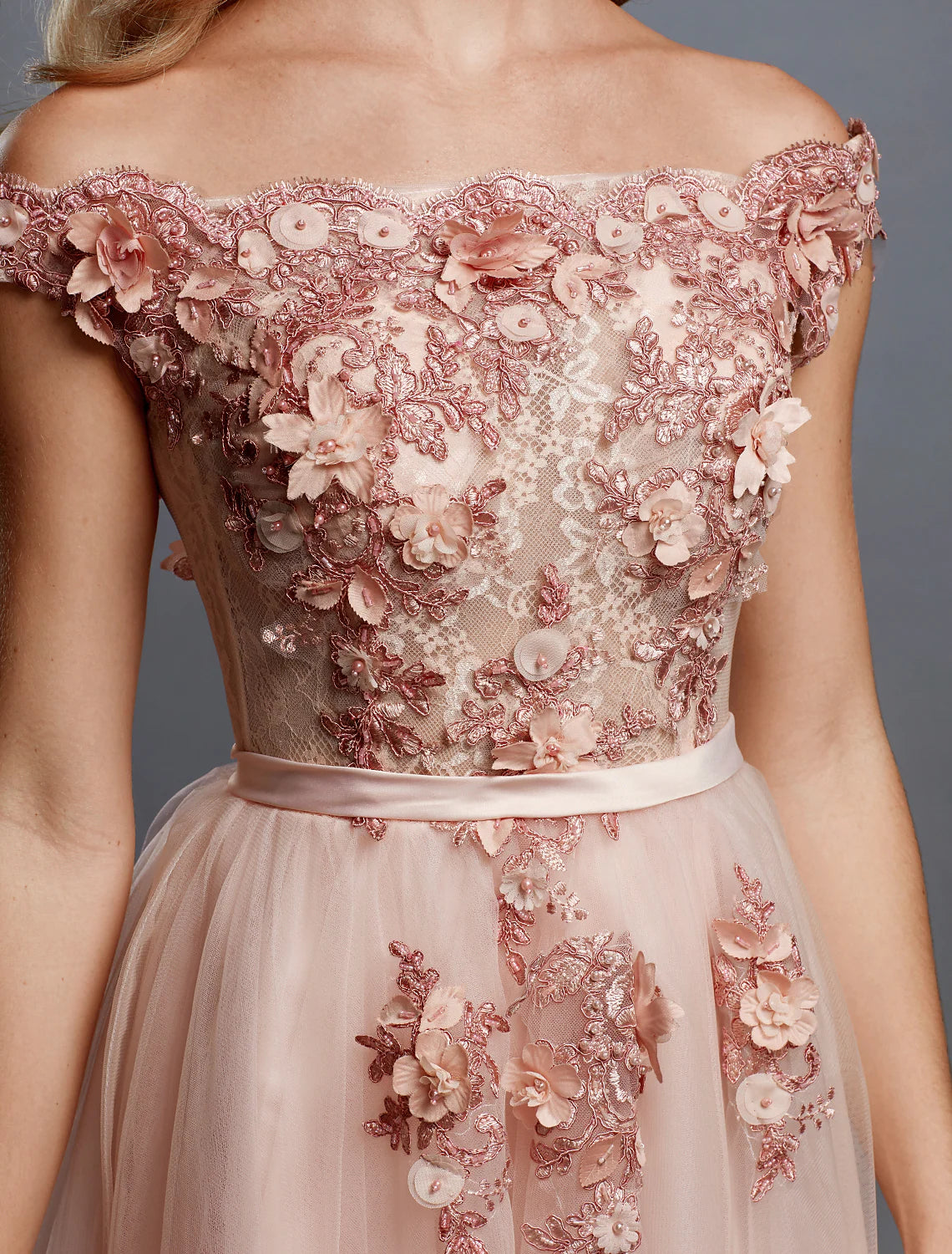 Side view of the floral lace off-shoulder gown, highlighting the A-line silhouette.