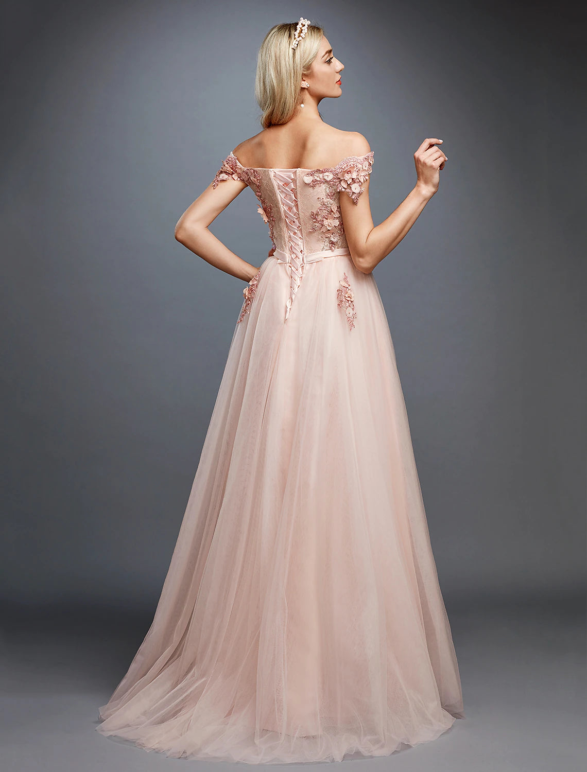 Model posing in the A-line off-shoulder gown, showing the full length.