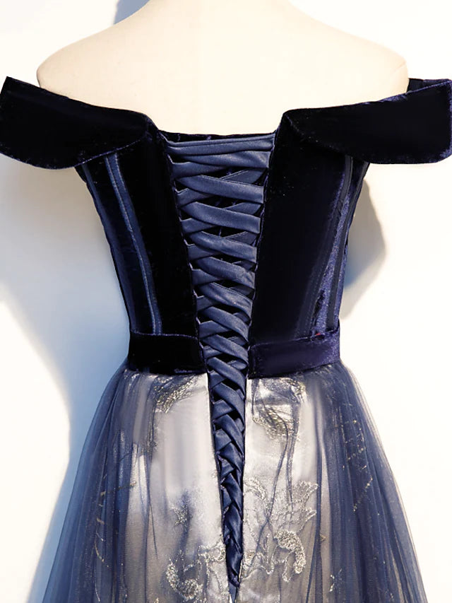 Close-up of floral pattern and pleated tulle fabric on the dress.