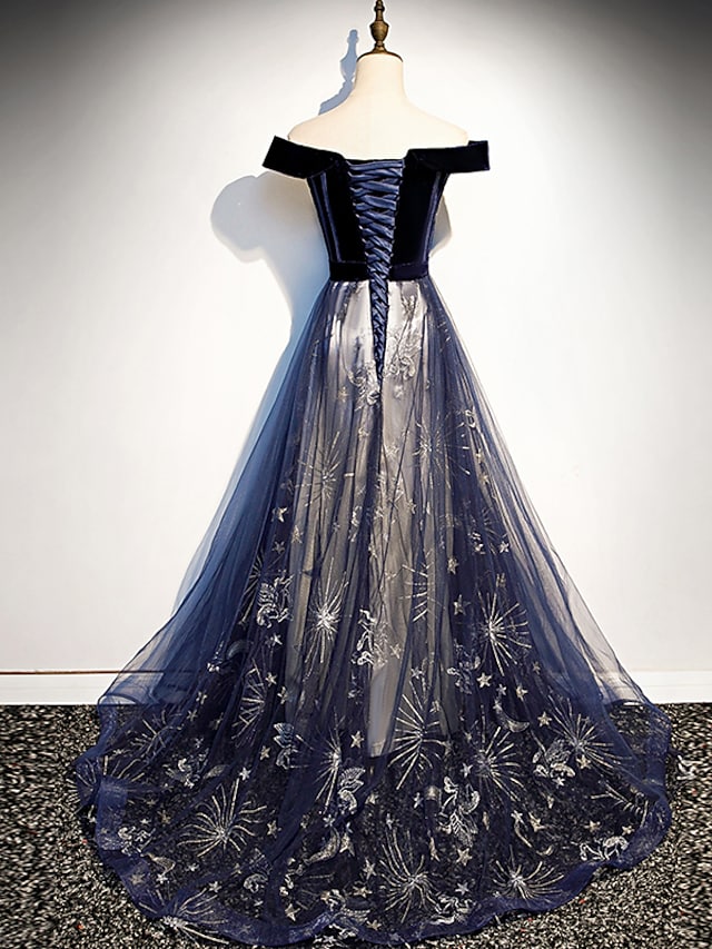 Model wearing A-line floral off-shoulder tulle dress at a formal event.