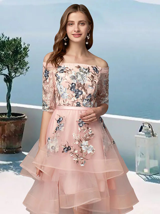 Close-up of floral embroidery and appliques on off-shoulder dress bodice.