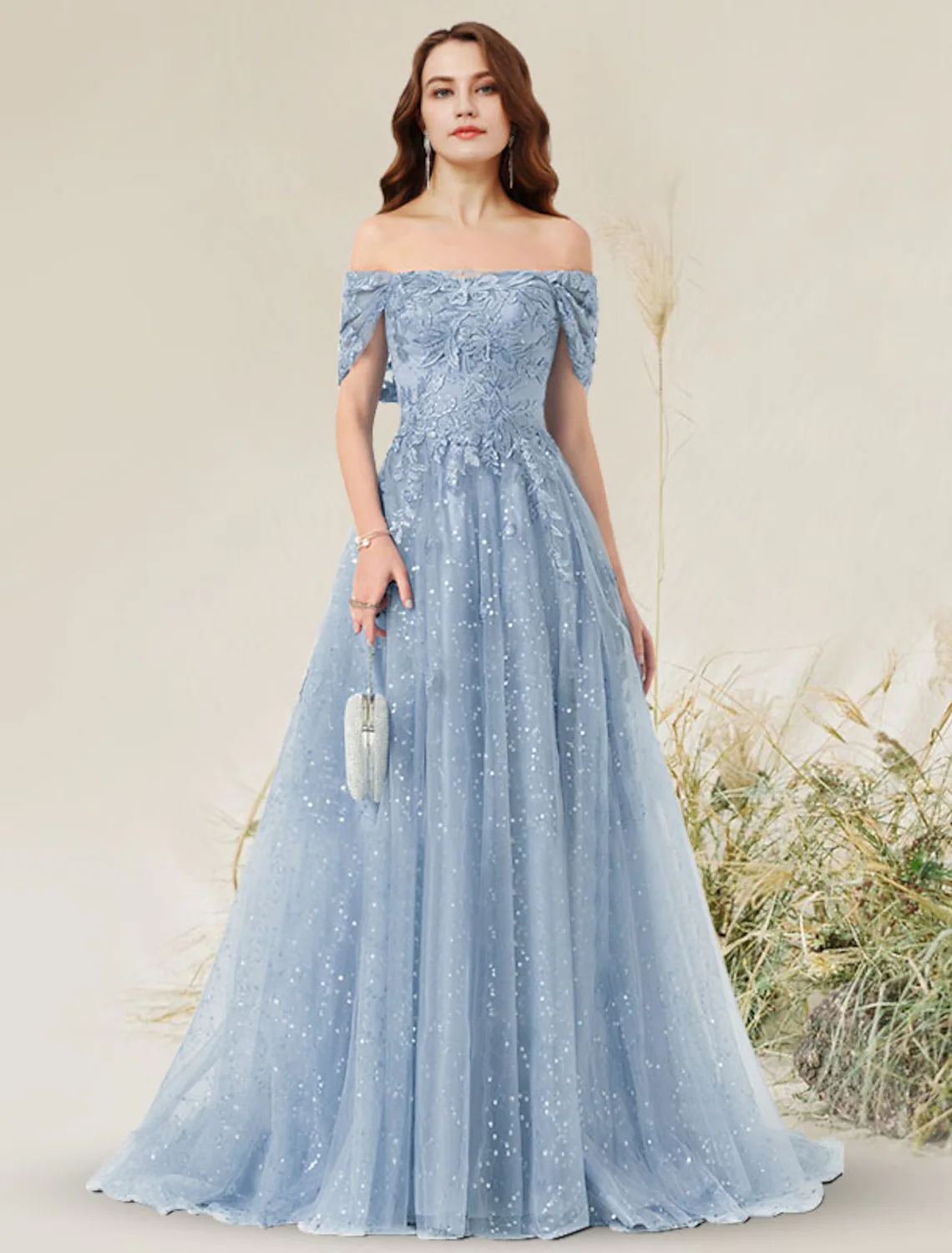 Close-up of lace and pleated details on the off-shoulder dress.