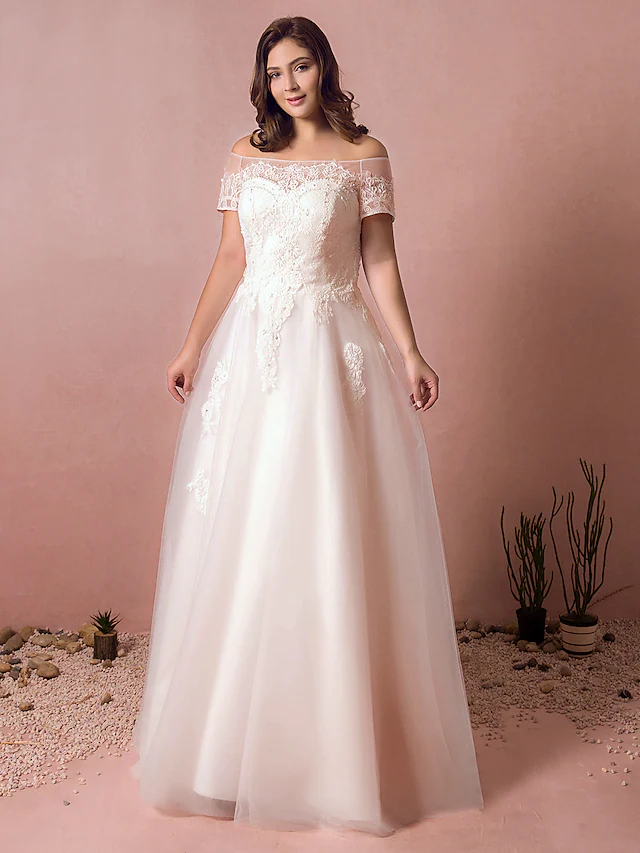 Elegant A-line off-shoulder wedding dress with lace details and short sleeves.